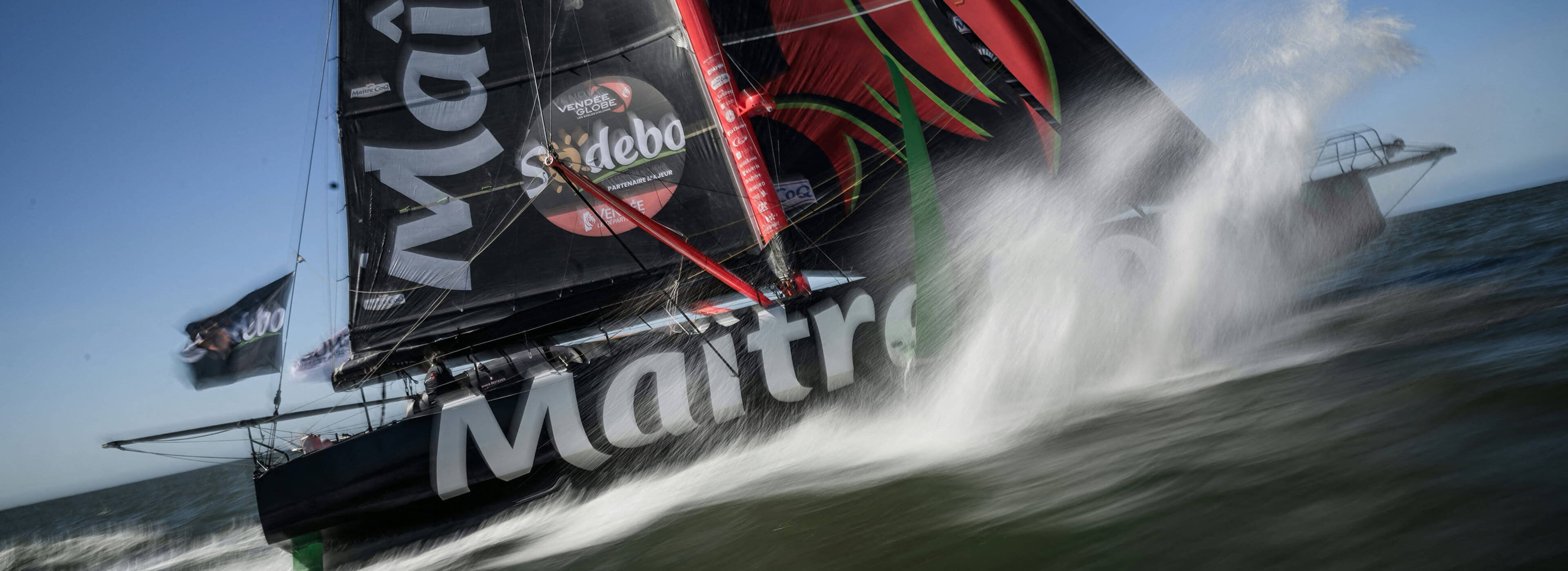 Crew sailing on racing yacht