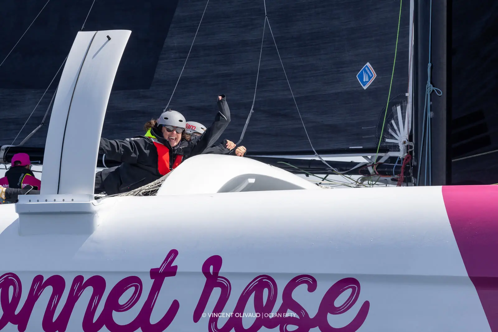 Crew sailing on racing yacht